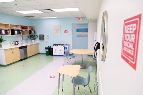 School cafeteria with social distancing signs