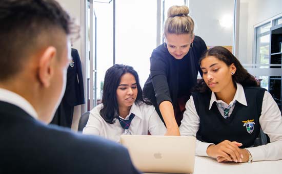 Students getting help for teacher