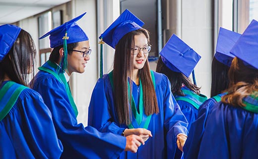 Alexander Academy Students talking during graduation