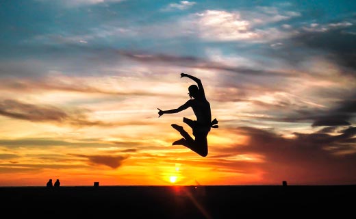 Silhouette of Female jumping for joy